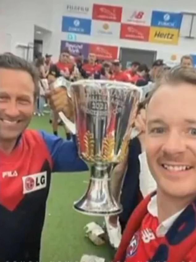 Burbank (left) hopped the border into the Northern Territory before traveling to WA to watch the Melbourne Demons win at Perth Stadium.