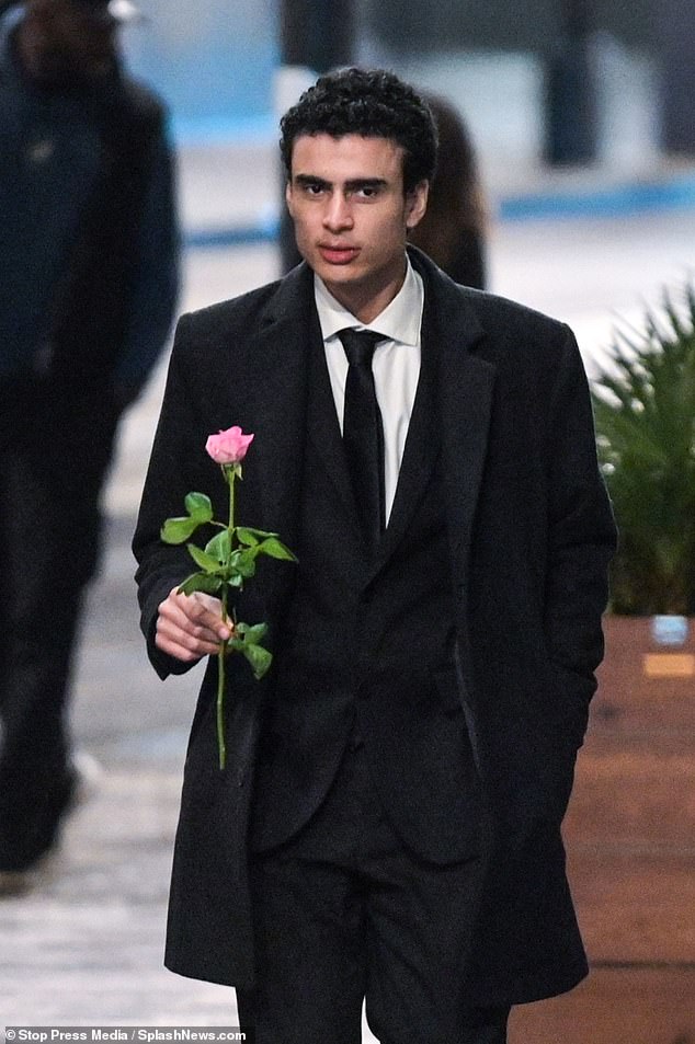 A man got into the Valentine's Day spirit when he was seen walking down the street wearing a smart black suit and holding a pink rose.