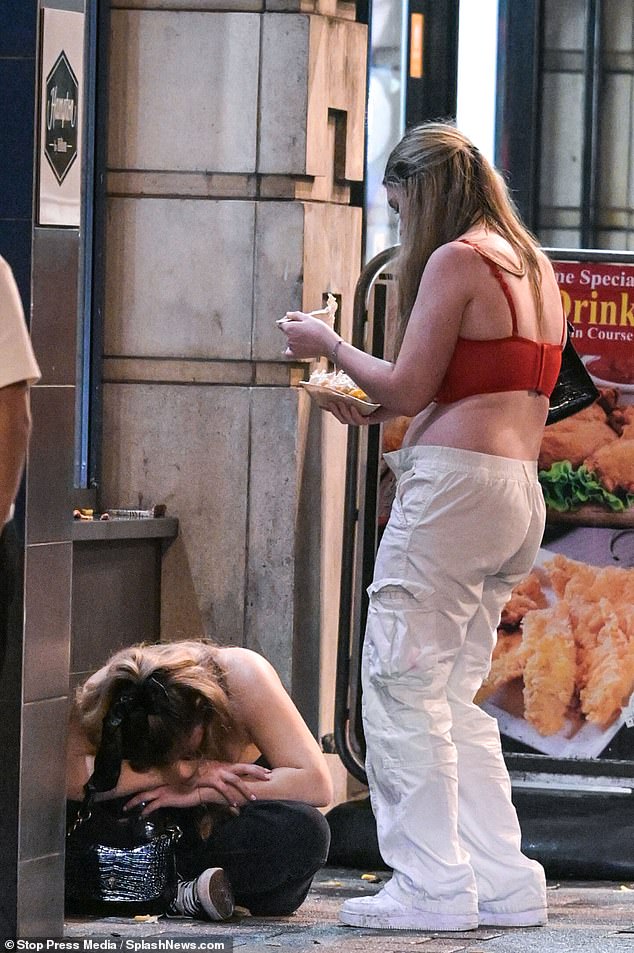 As night turned to morning and the clubs closed, friends were seen looking out for each other and a girl was seen enjoying cheese fries while standing over her friend slumped on the floor.