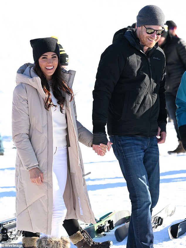 Harry and Meghan, holding hands and smiling on Valentine's Day in Whistler, Canada, yesterday afternoon.
