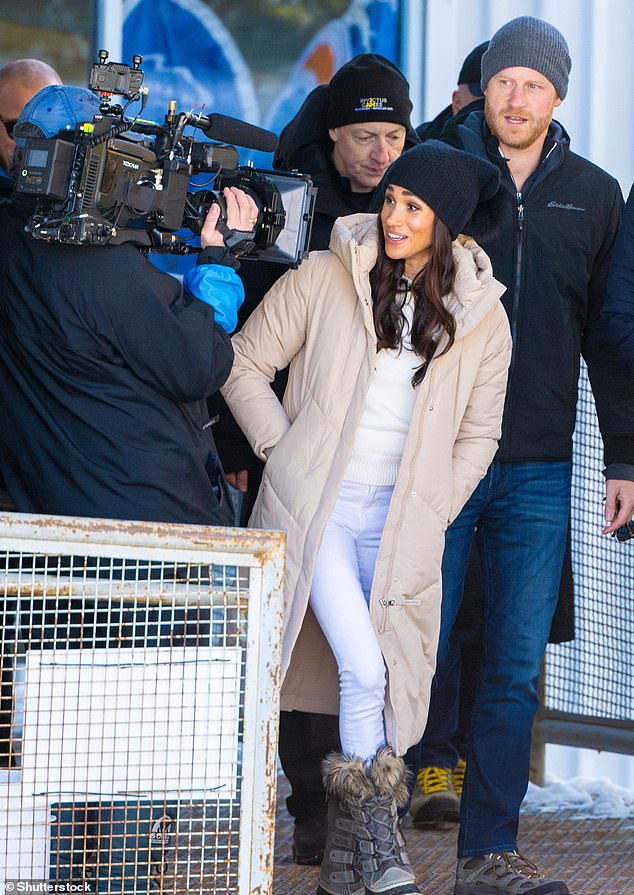 Meghan led the way as she and Harry were filmed arriving at the Valentine's Day publicity event.