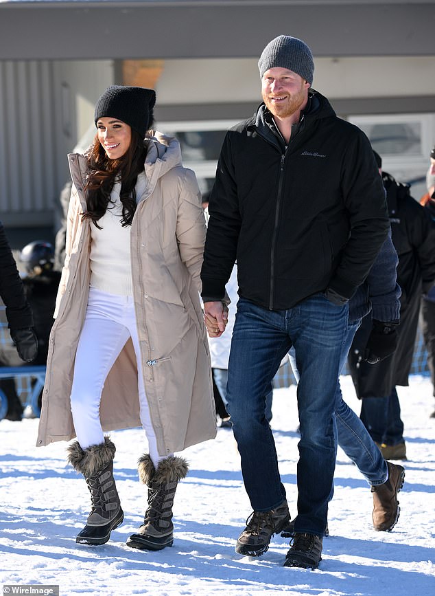 The couple smiled as they walked through the snow in Canada yesterday.