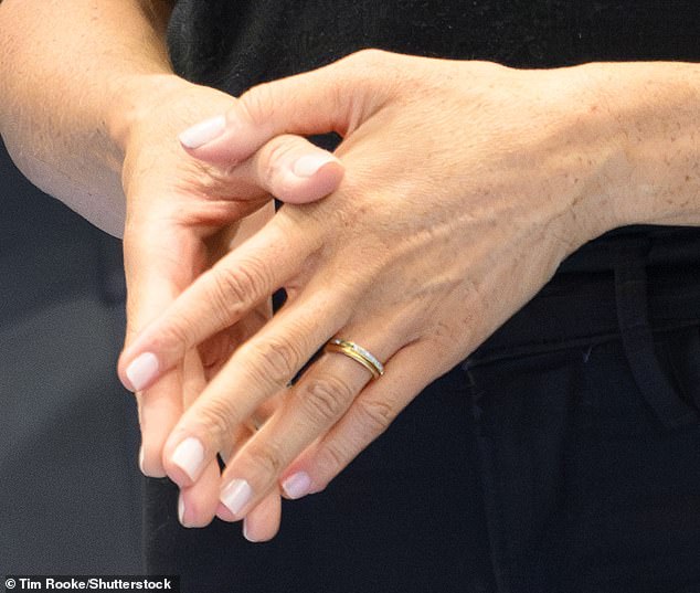 Pictured are Meghan's hands without her engagement ring while at the Invictus Games in September 2013.