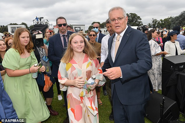 Prime Minister Scott Morrison pictured with his daughters Lily and Abbey after the Australia National Day flag-raising and citizenship ceremony in Canberra on Wednesday, January 26, 2022.