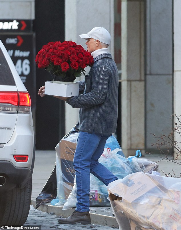 The supermodel was spotted outside her Big Apple apartment when a courier service dropped a stunning array of red roses on her doorstep on Wednesday.