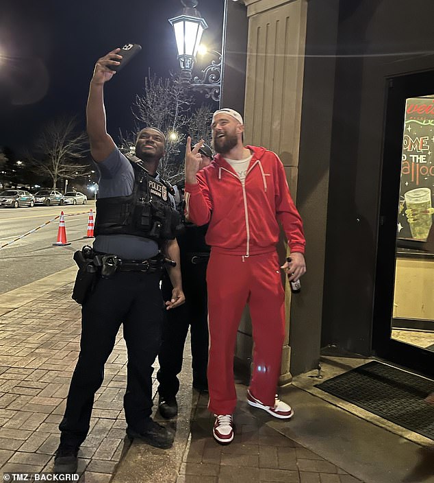 Just hours after 22 fans were shot, Kelce thought it was a great idea to go to the 'Granfalloon Restaurant and Bar' and take selfies with cops while carrying an open bottle of beer on the street, after having walked onto the parade stage looking too drunk to talk.