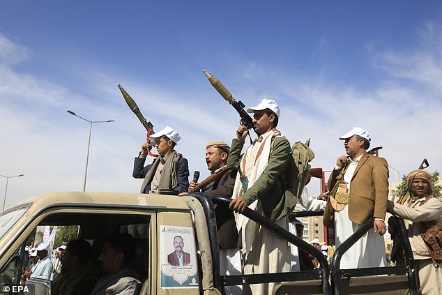New Houthi recruits ride in a vehicle during a parade against the United States and Israel, in Sana'a, Yemen, on February 7.
