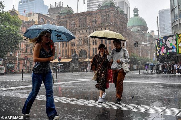 The rest of the week looks gray in Sydney with rain forecast over the weekend and into the middle of next week (pictured, people sheltering from the rain)