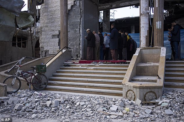 Palestinians pray at a mosque damaged after an Israeli attack in Rafah, in the southern Gaza Strip.