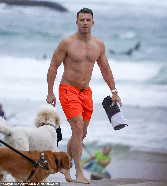 A shirtless Todd flaunted his six-pack abs as he worked out by the sea in just a pair of bright orange shorts at Bondi Beach on Wednesday.