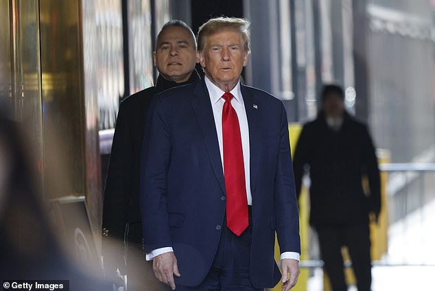 Trump turns toward the cameras as he leaves Trump Tower Thursday morning before the hearing.