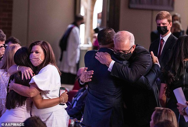 Australian Prime Minister Scott Morrison (right) and his wife Jenny hug members of the Abdallah family during a church service in February this year.
