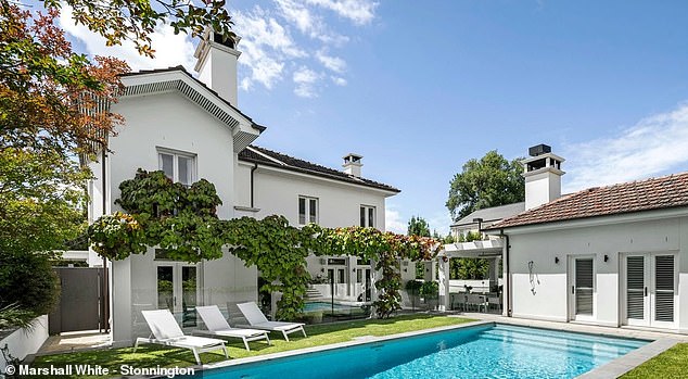Located in a prestigious suburb of Melbourne, the sprawling home features five and four bedrooms, a swimming pool and a tennis court.  In the photo: the pool area.
