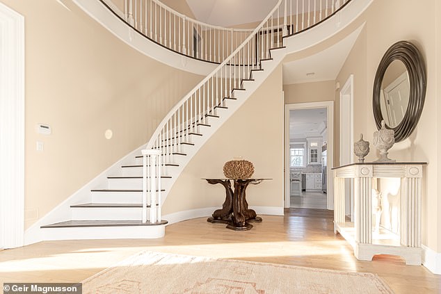 The residence is further complemented by a three-car garage, porte-cochere and finished basement, enhancing the charm of this Hamptons gem, according to the agent. In the photo: the large hall