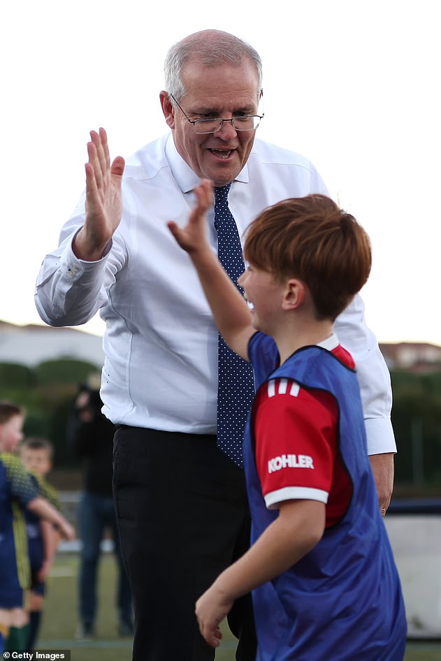 Some people joked that Morrison looked as young as a child he accidentally accosted on Wednesday. Both Mr Morrison and the boy were uninjured and high-fived after the accidental collision (pictured).