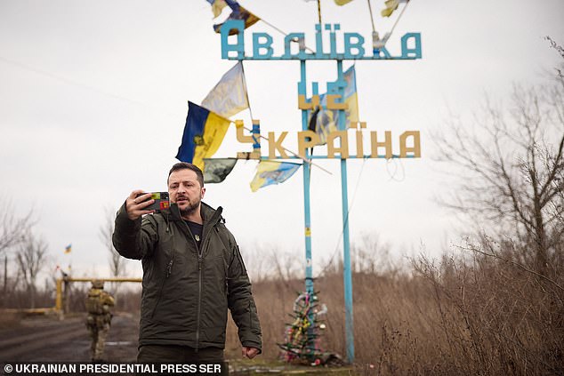 This photograph taken and released by the Ukrainian Presidential Press Service on December 29, 2023 shows Ukrainian President Volodymyr Zelensky recording a video speech in front of a sign that reads 