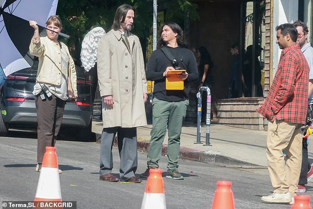 Speaking of Lionsgate, Keanu is currently hard at work playing a mysterious character clad in angel wings on the set of Aziz Ansari's (R, pictured Tuesday) directorial debut, Good Fortune.