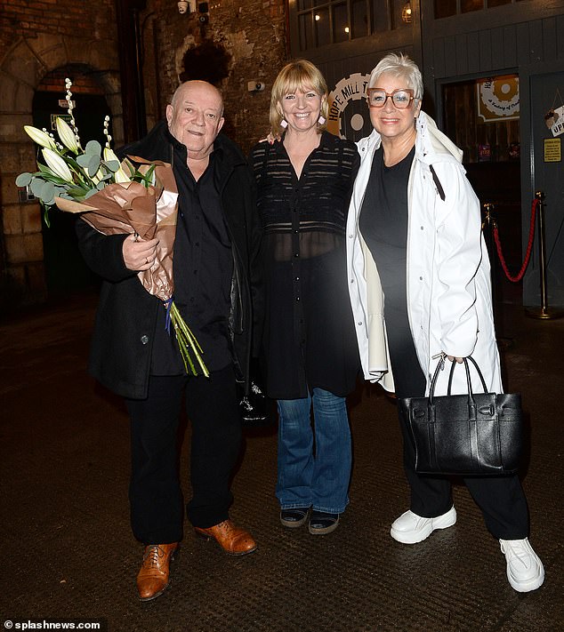 The rocker is the son of actress and Loose Women star Denise, 65 (right) and actor Tim Healy (left), who attended the Manchester performance with his wife Joan Anderton (centre).