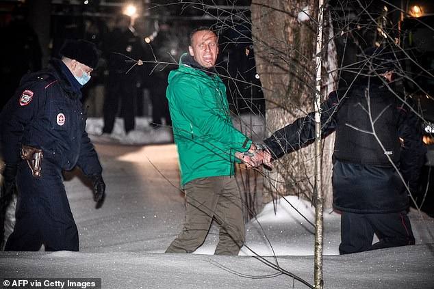 Opposition leader Alexei Navalny is escorted out of a police station on January 18, 2021.