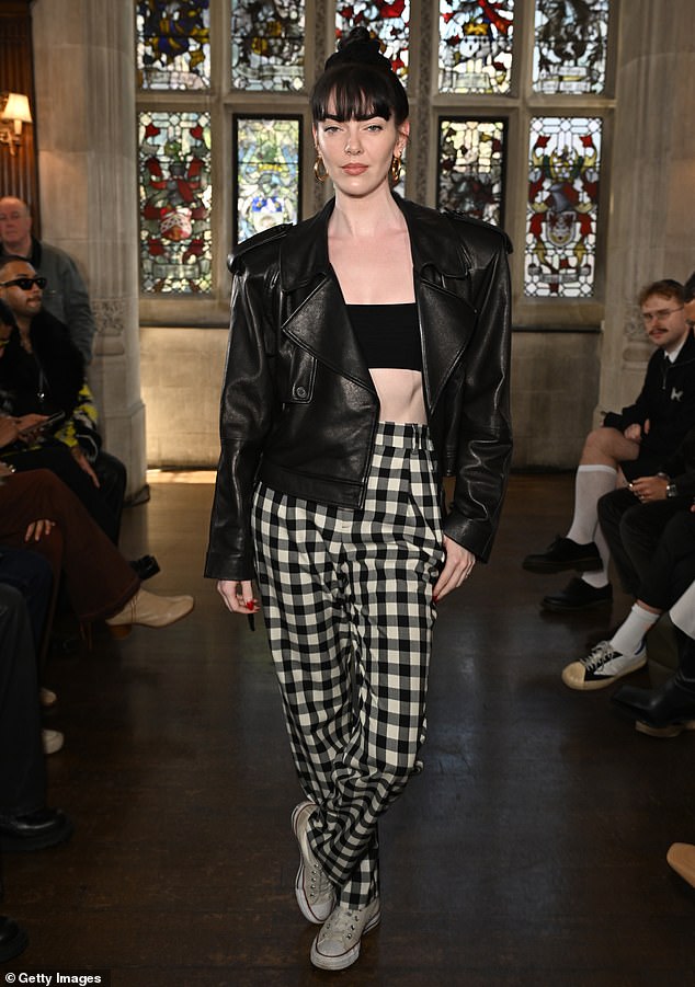 Photographer Zoë Zimmer stunned in high-waisted plaid pants, a black bandeau top, and worn-out Converse.