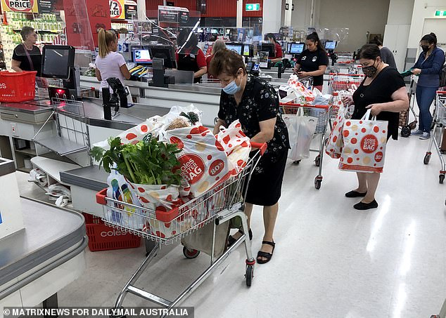 The Prime Minister added that if re-elected, Australians would not return to daily press conferences or be under the threat of lockdowns (pictured, shoppers wearing masks in a Sydney supermarket).