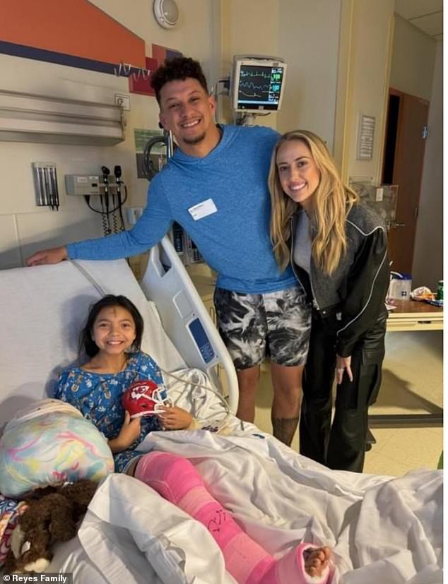 The NFL star and his wife posed with the two girls who underwent surgery after being shot in the leg during Wednesday's parade. Eight-year-old Meliá, whose forehead was marked with ashes during Lent, is seen smiling as she holds a mini Chiefs football helmet.