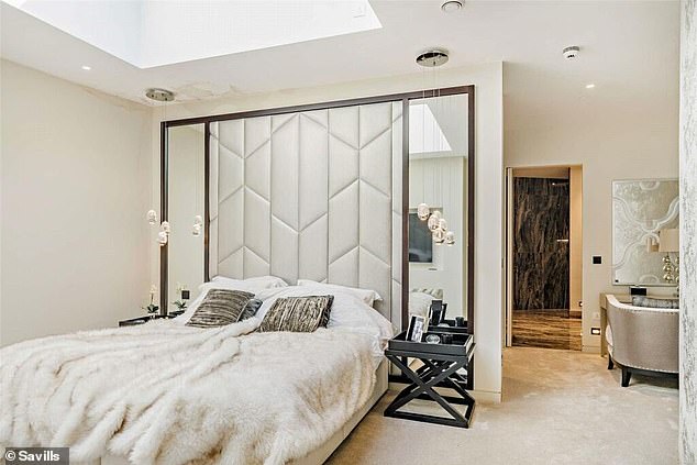 There are three bedrooms that are located on the outer edge of this lower circular level, and this bedroom features a skylight.