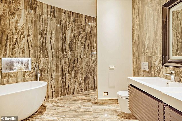 There are three bathrooms, including this one with large slabs of colorful decorative marble.