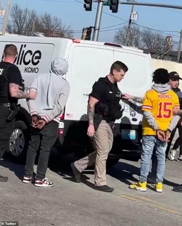 Two unnamed juveniles have been charged with crimes related to the mass shooting at the Kansas City Chiefs Super Bowl rally. It is unclear if they were the young men detained in the photo above taken after the shooting.