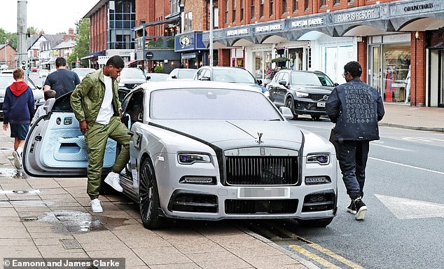 Rashford (left) was previously seen getting into the £700,000 car outside a Cheshire jewelery shop.