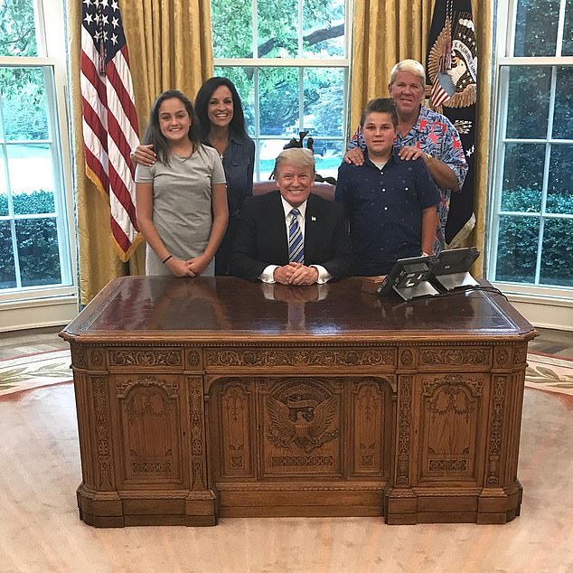 Daly is pictured with his family and 'great friend' Trump in the Oval Office in 2017.