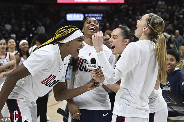 UConn forward Aaliyah Edwards, guard Aubrey Griffin, guard Nika Muhl and guard Paige Bueckers cheer on UConn as they conclude senior night ceremonies in Storrs.