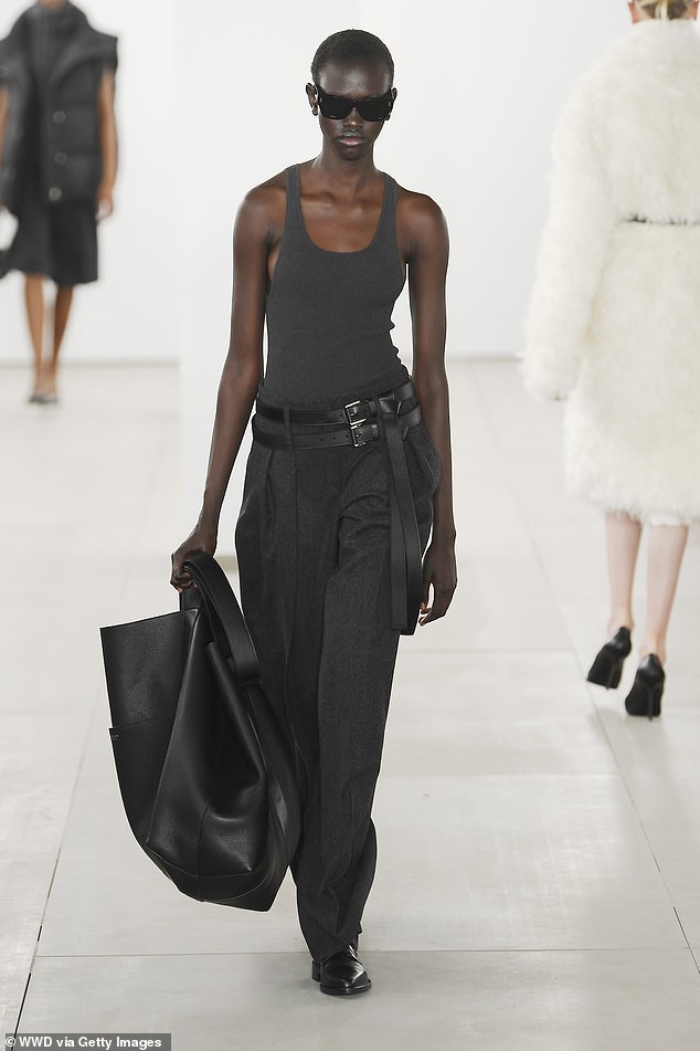 An oversized clutch is functional and can serve as the focal point of an outfit, as seen at Michael Kors.