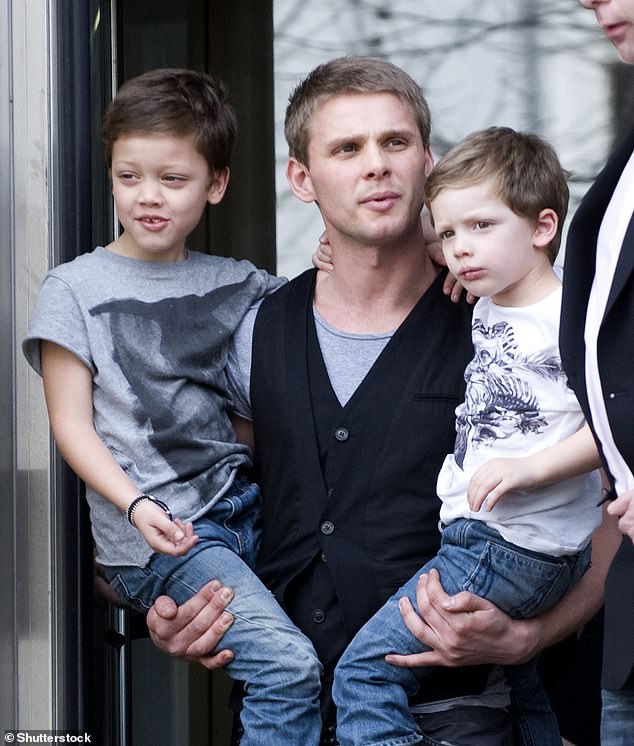 Jeff Brazier holding his sons Bobby and Freddie after Jade's baptism in March 2009.