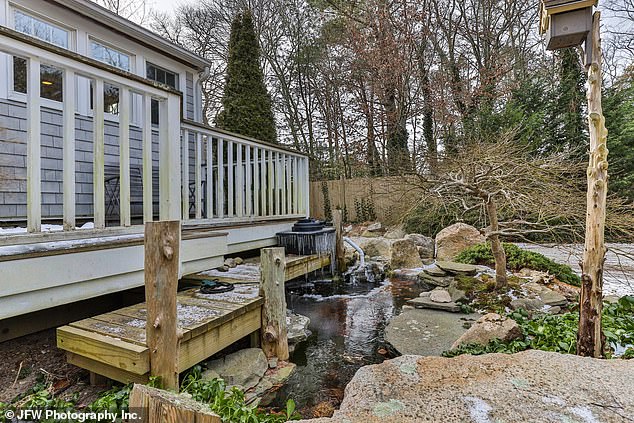 The backyard of the home features two goldfish ponds, a patio, and a gazebo in a private setting.