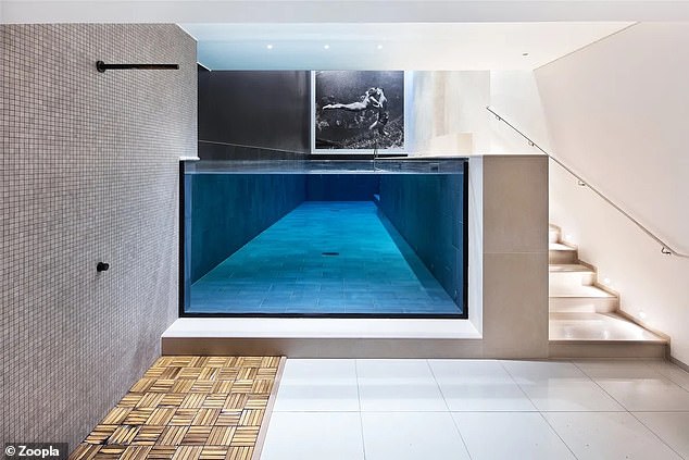 There is a stunning double-height swimming pool in the sophisticated basement of the property.