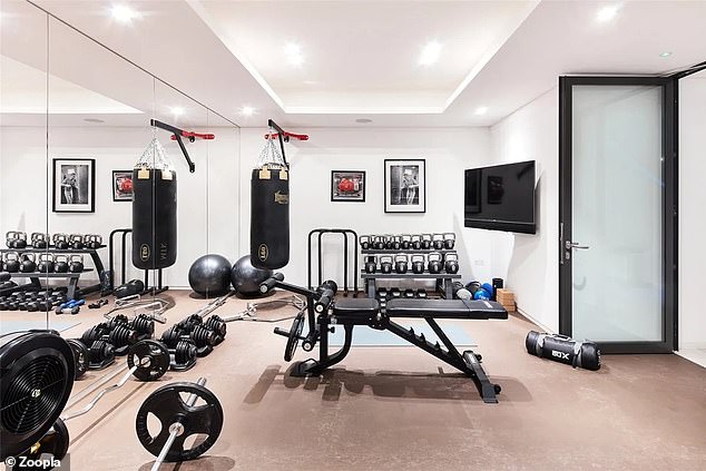 The well-equipped gym has floor-to-ceiling mirrors along one wall.