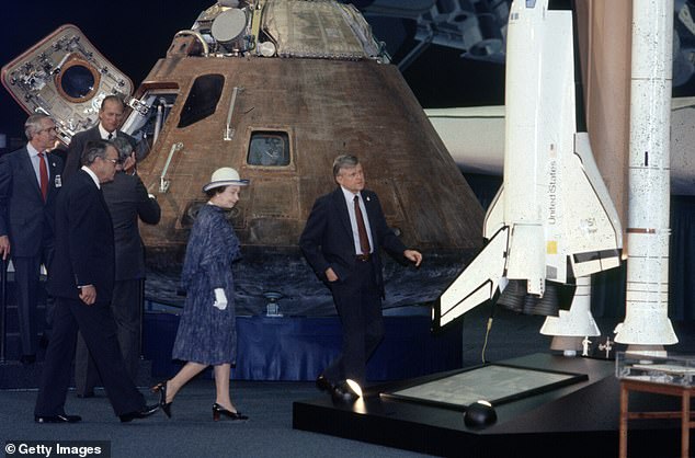 Queen Elizabeth II and Prince Philip view the Apollo 14 module and model of the space shuttle during a tour of the Rockwell International space facility in 1983.