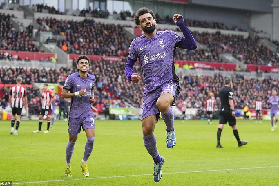 Salah jumps for joy in front of the traveling Liverpool fans at the Gtech Community Stadium after scoring three to zero.