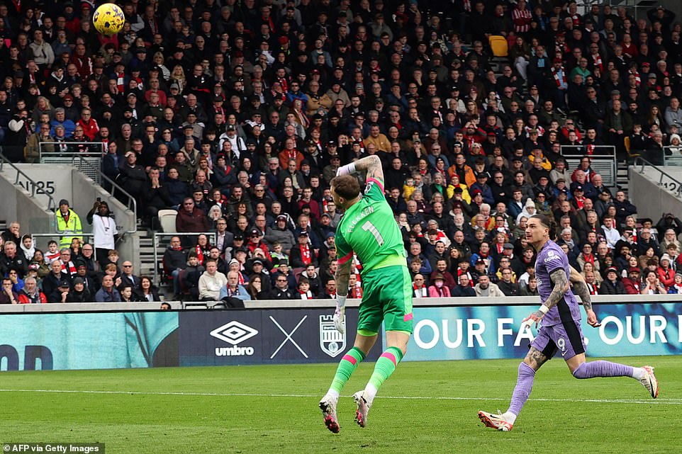Darwin Núñez hits the perfect lob to beat Brentford goalkeeper Mark Flekken and give Liverpool the lead in the first half.
