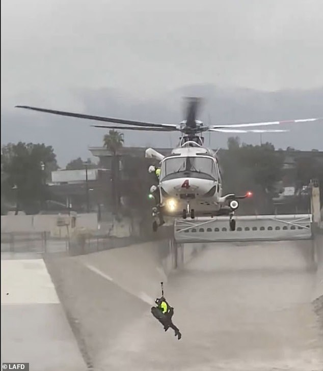 In a dramatic river rescue, a Los Angeles Fire Department helicopter crew pulled a man from the turbulent waters of the Los Angeles River after his dog fell.