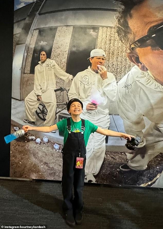 Kourtney also shared a photo of her seven-year-old son Reign, smiling while posing in front of a poster of Travis and his Blink-182 bandmates. He also brought his 11-year-old daughter Penelope to the show.