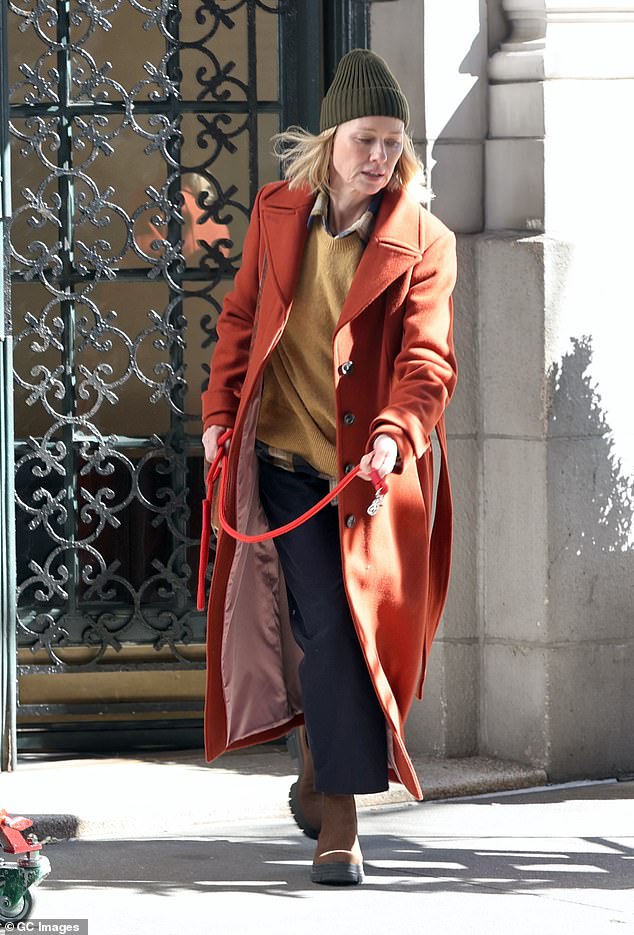 The British actress was bundled up in an olive green hat, with her hair loose underneath, and a long burnt orange coat.