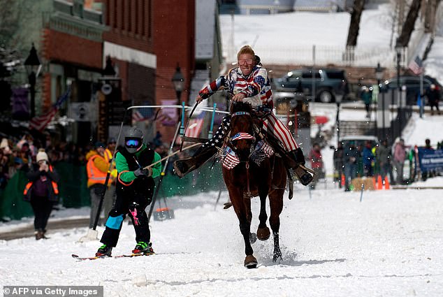 Rider Taylor Stobaugh races down Harrison Avenue as the skier and Shawn Gerber navigate the course during the 74th annual Leadville Ski Joring Weekend Competition on March 5, 2022 in Leadville, Colorado.