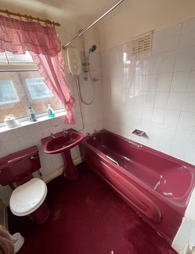 The dated maroon carpeted floor is replaced with light gray granite tiles, while the bright red plastic bathtub is transformed into a spacious tiled tub equipped with matte black faucets and shower head.