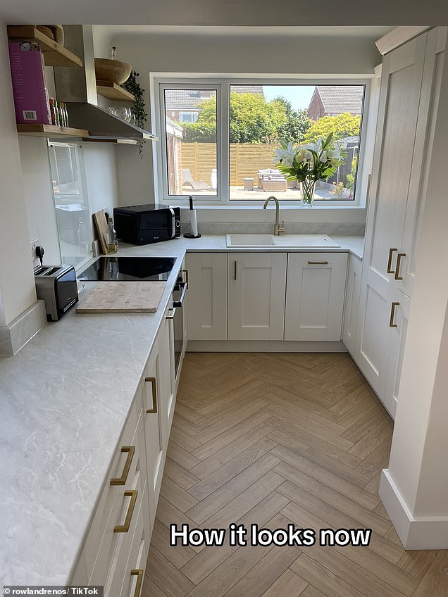 Pine floors and minimalist white units were then installed, topped with light gray marble worktops and finished with gold handles attached to drawers and cupboards.