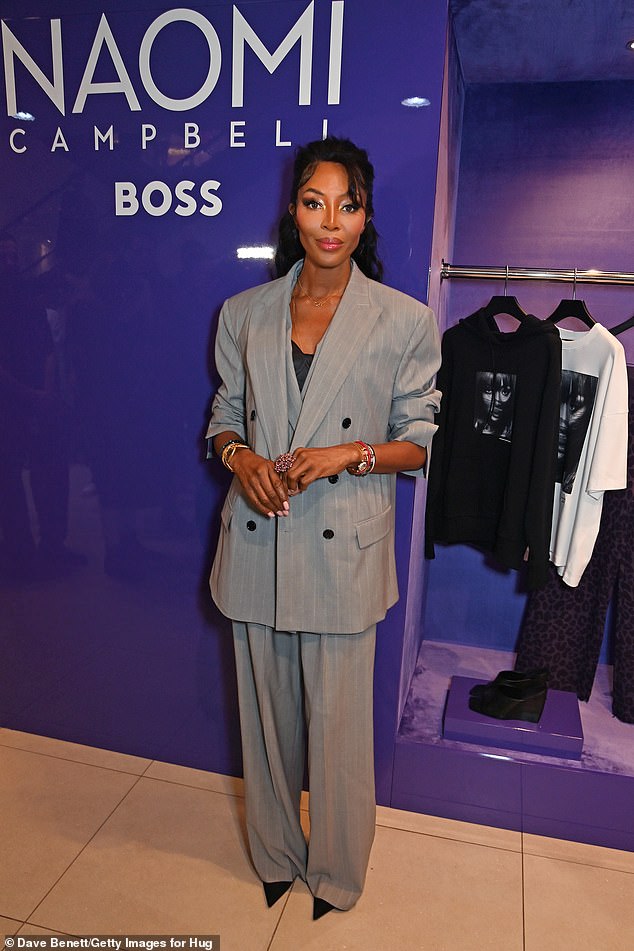 The iconic supermodel revealed a black bustier underneath an oversized gray suit from the range which featured a double-breasted jacket and wide-leg trousers.