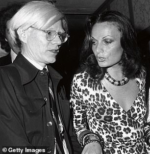 Diane wearing a leopard print version with Andy Warhol in 1974, the year it was released.