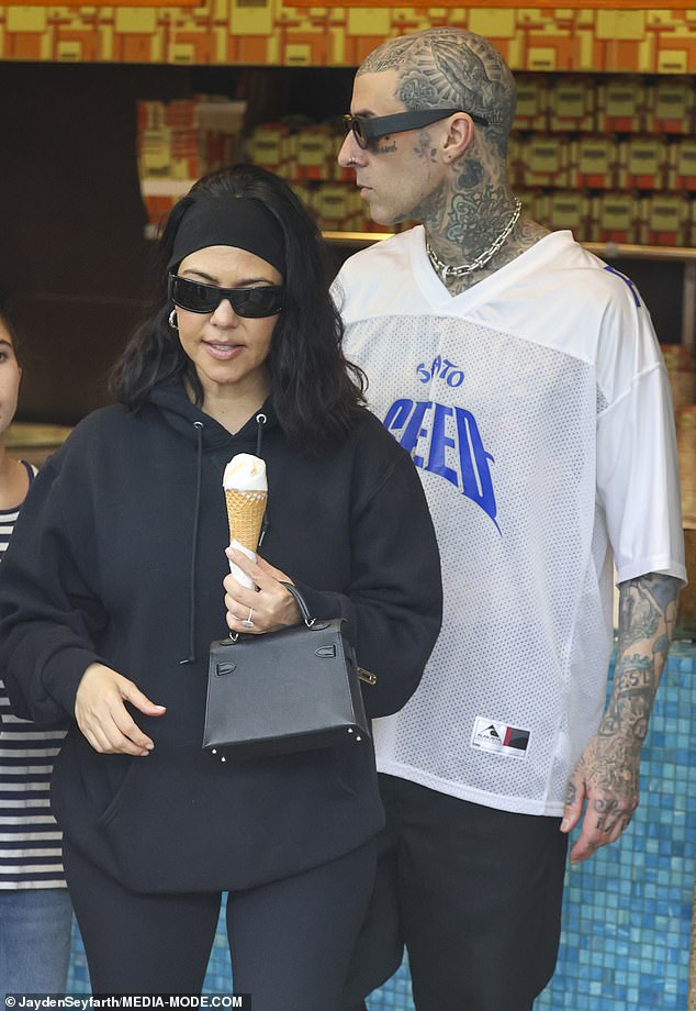 Standing in the crowded window, Kourtney was seen selecting flavors with her children, who she shares with ex Scott Disick, while also choosing what appeared to be a vanilla ice cream cone for herself.