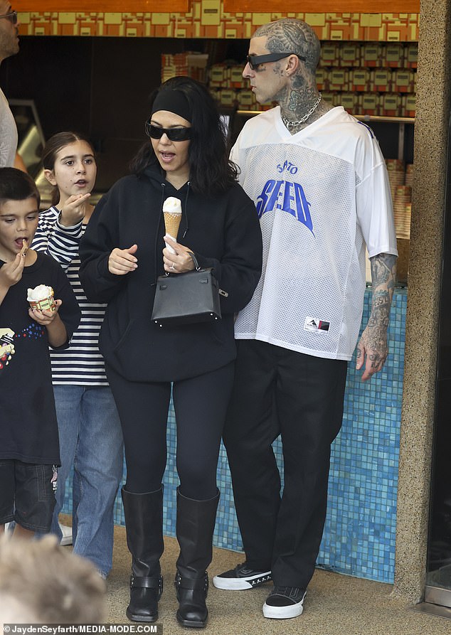 Kourtney, who just a few weeks ago gave birth to her first baby, a son named Rocky, with Travis, looked relaxed in a loose-fitting hoodie, black leggings, and leather boots with studded details.
